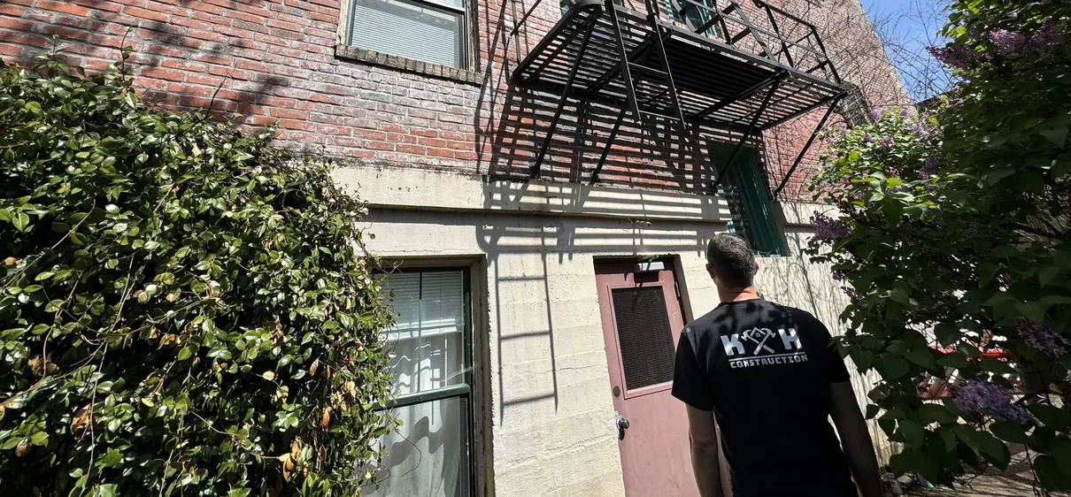K and H technician assessing a fire escape during an on-site evaluation in Portland