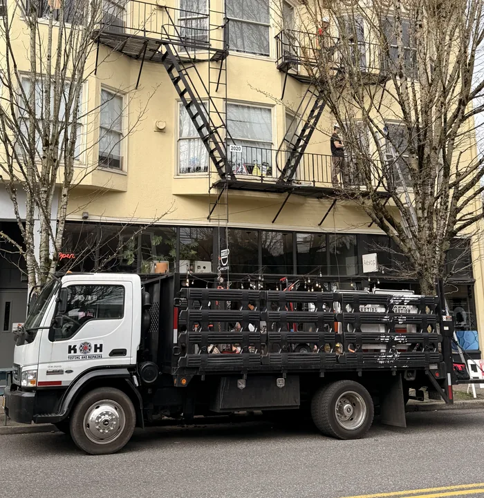 K and H Testing and Repairs truck and crew at a Portland fire escape testing jobsite